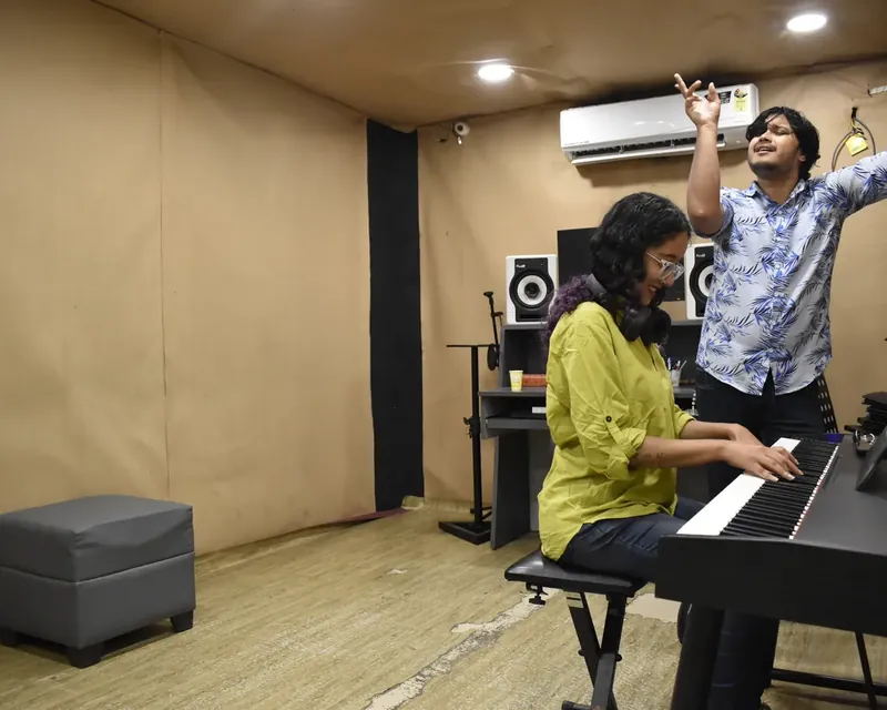 A vocal student singing with a Prism teacher at the keyboard