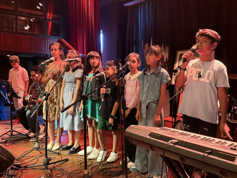 The ensemble on stage, Origin Story